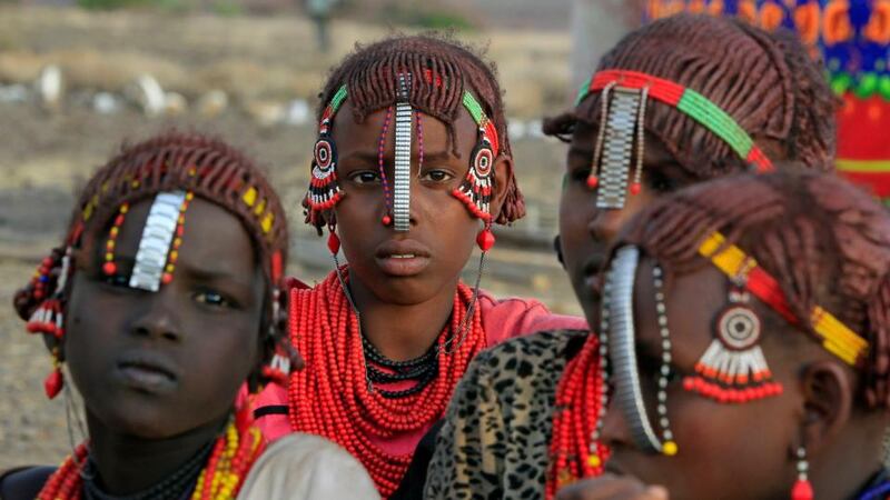 Girls from the Daasanach tribe sit outside their hut at the venue of a welcoming ceremony for tourists ahead of the hybrid solar eclipse expected to take place today, at the remote Sibiloi National Park on the shores of Lake Turkana in Kenya. Photograph: Reuters