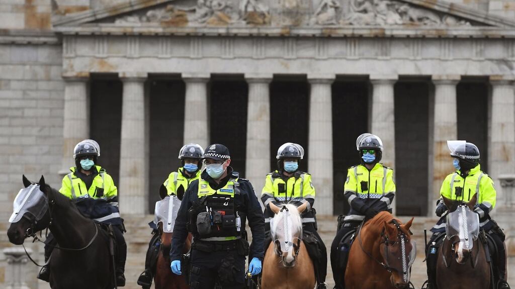 Police stand guard in front of the Shrine of Remembrance during an anti-lockdown rally in Melbourne on Saturday as the city continues to enforce strict lockdown measure to battle a second wave of Covid-19 coronavirus infections. Photograph: William West/ AFP/Getty
