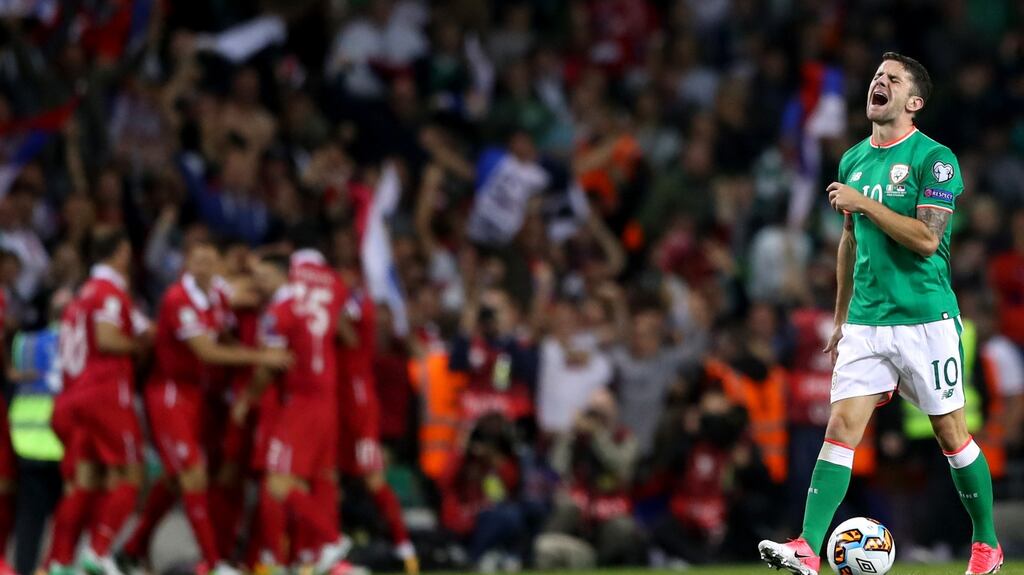 Ireland’s Robbie Brady reacts after  Serbian players celebrate  celebrate Aleksandar Kolarov’s goal. Photograph: James Crombie/Inpho