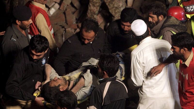 Rescue workers carry out an injured man after a factory collapsed near the eastern city of Lahore, Pakistan, November 4th, 2015. Photograph: Mohsin Raza/Reuters
