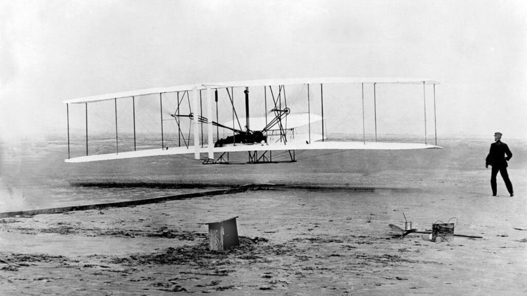 Orville Wright, at the controls of the Wright Flyer, and his brother Wilbur, watch from the ground during the plane’s first flight in 1903. Photograph: AP Photo/File