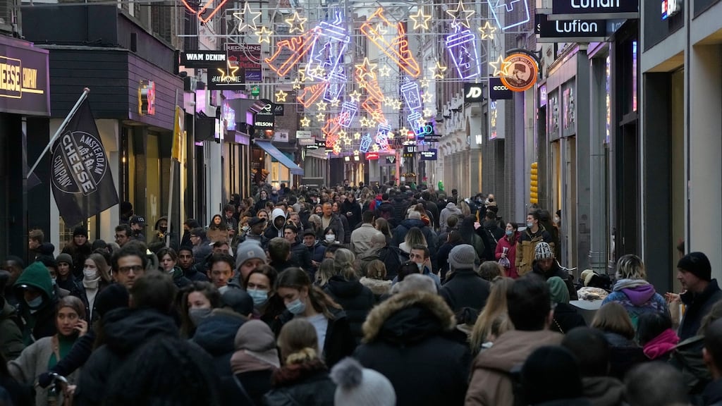 Crowds of people walk down a street on the last Saturday before Christmas in Amsterdam, before the country went into a new lockdown. Photograph: Peter Dejong/AP