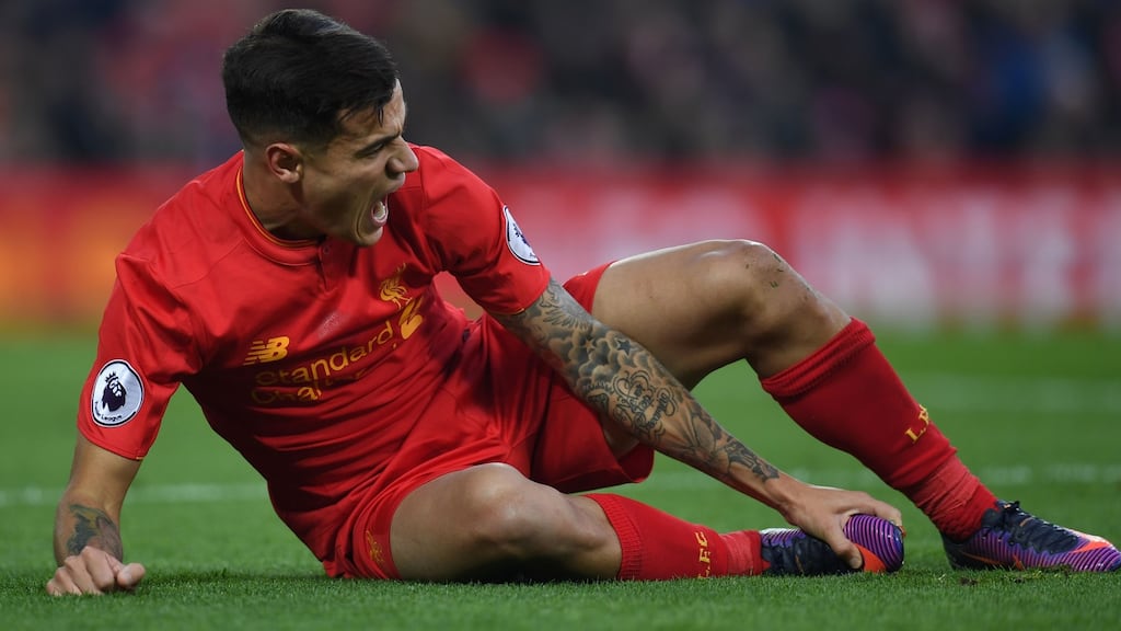Liverpool’s Brazilian midfielder Philippe Coutinho holds his foot after his injury against Sunderland. Photograph: Paul Ellis/AFP/Getty Images