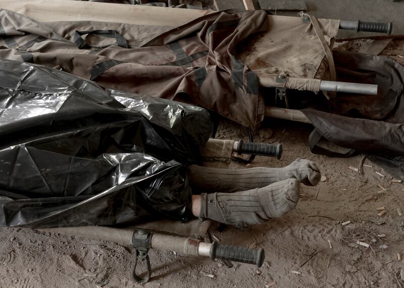 The body of a Ukrainian solder, placed on a stretcher before being transferred to the morgue. Photograph: Emile Ducke/The New York Times