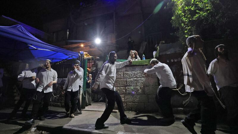 Israeli settlers dance in front of a house decorated with the Star of David in the Sheikh Jarrah neighbourhood of Israeli-annexed East Jerusalem on May 9th. Photograph: Emmanuel Dunand/AFP via Getty Images