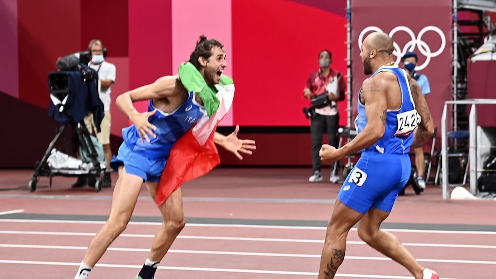 High jump golf medallist Gianmarco Tamberi of Italy congratulates team-mate Marcell Lamont Jacobs after his win in the 100 metres at the Olympic Stadium in Tokyo. Photograph: Christian Bruna/EPA