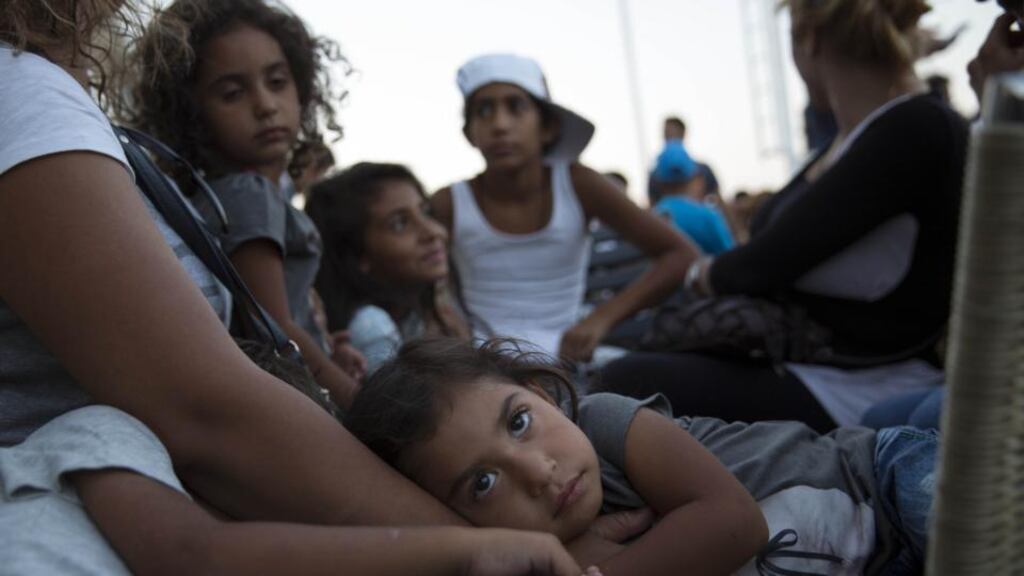 A young refugee rests with her family on the Blue Star ferry bound for Athens from Kos. Photograph: Dan Kitwood/Getty Images