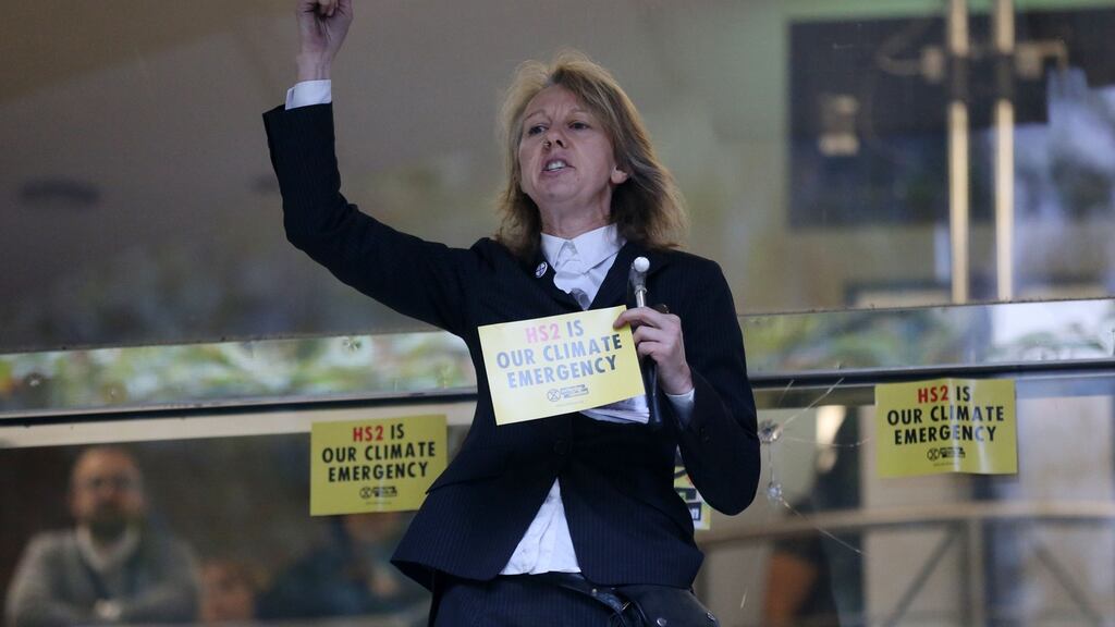 Gail Bradbrook, co-founder of Extinction Rebellion climate action movement, speaks before smashing a window at the front of the building housing the government’s Department for Transport in central London. Photograph: Isabel Infantes/AFPvia Getty Images