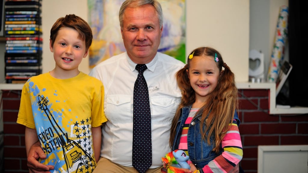 Rimantas Mickevicius with his children Rafael (8) and Marija (7). In the background is a painting by his late wife, Frida. Photograph: Aidan Crawley