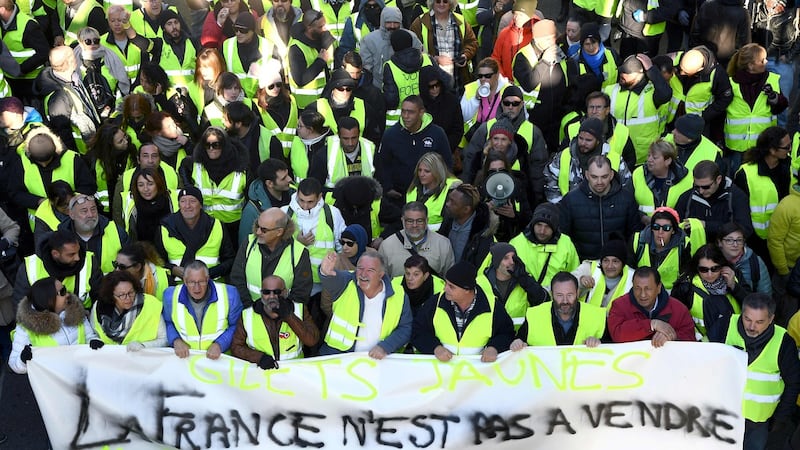 Protesters wearing yellow vest (gilet jaune) holds a sign reading “France is not for sale” during a demonstration to protest against rising costs of living they blame on high taxes in Marseille on Saturday. Photograph: Boris Hovart/ AFP/Getty Images