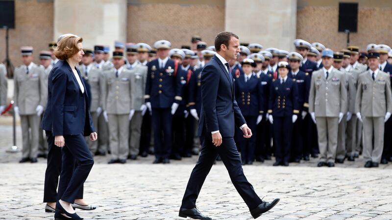 Emmanuel Macron walks with defence minister Florence Parly during a medal presentation ceremony  at the Hotel des Invalides, in Paris, on Friday. Photograph: Thibault Camus/EPA