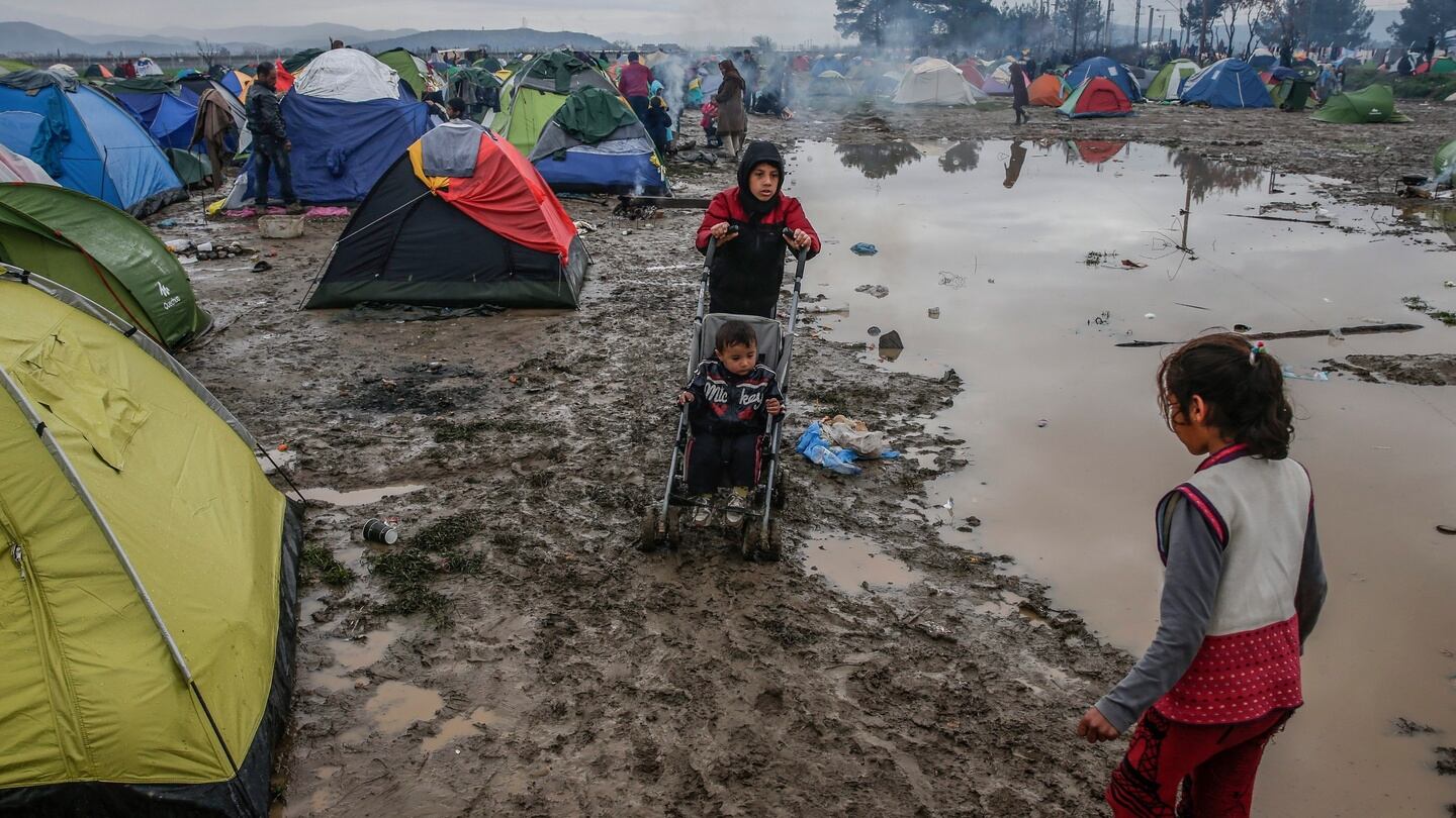 Refugees are seen in a camp at the border between Greece and Macedonia. Photograph: EPA