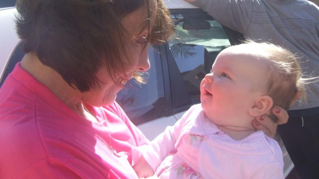 Baby love: Sharon Hutchinson meets her granddaughter Ella for the first time, at Perth Airport