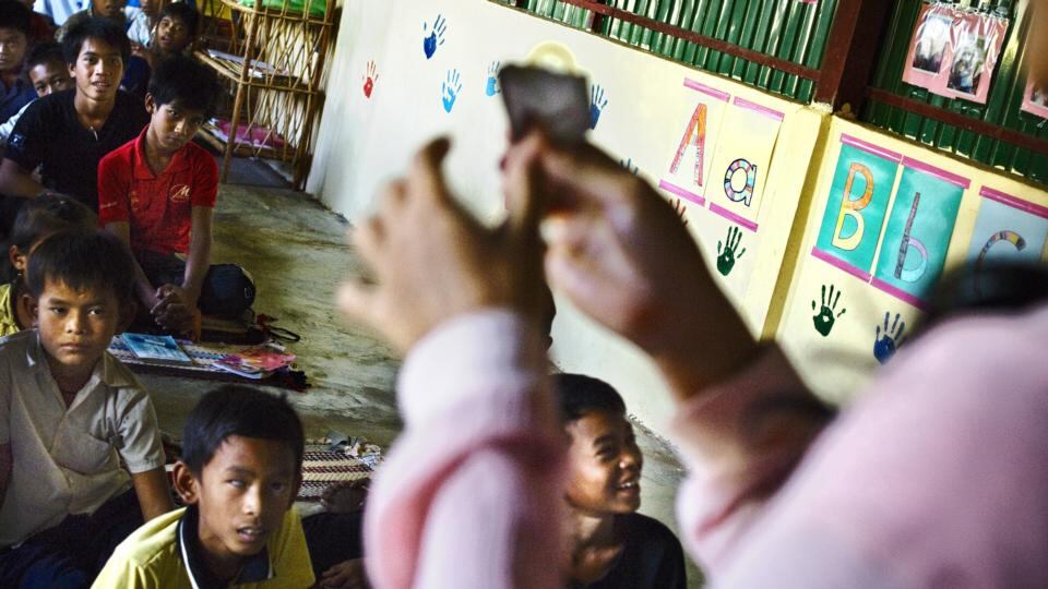 A teacher in Battambang, Cambodia, explains how to use a condom to the students’ delight. Photograph: Jonas Gratzer/LightRocket via Getty Images