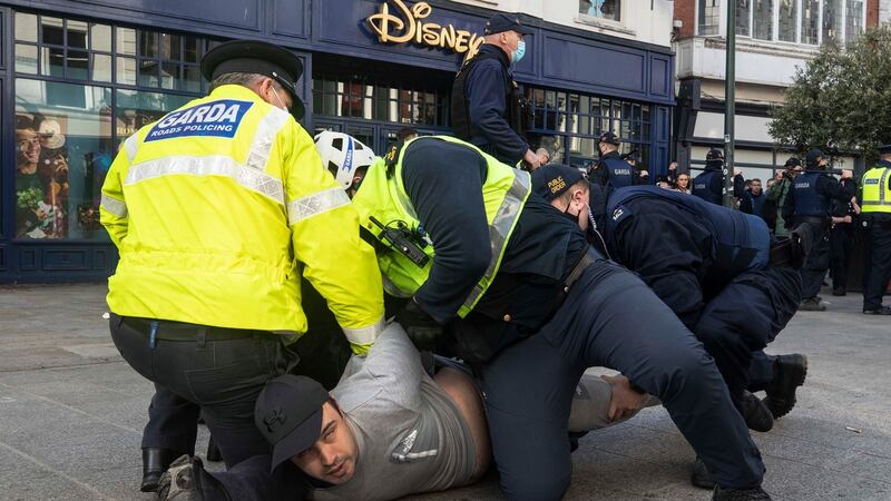 Gardaí restrain a protester during an anti-lockdown protest in Dublin city centre  on Saturday.  Photograph: Damian Eagers/PA