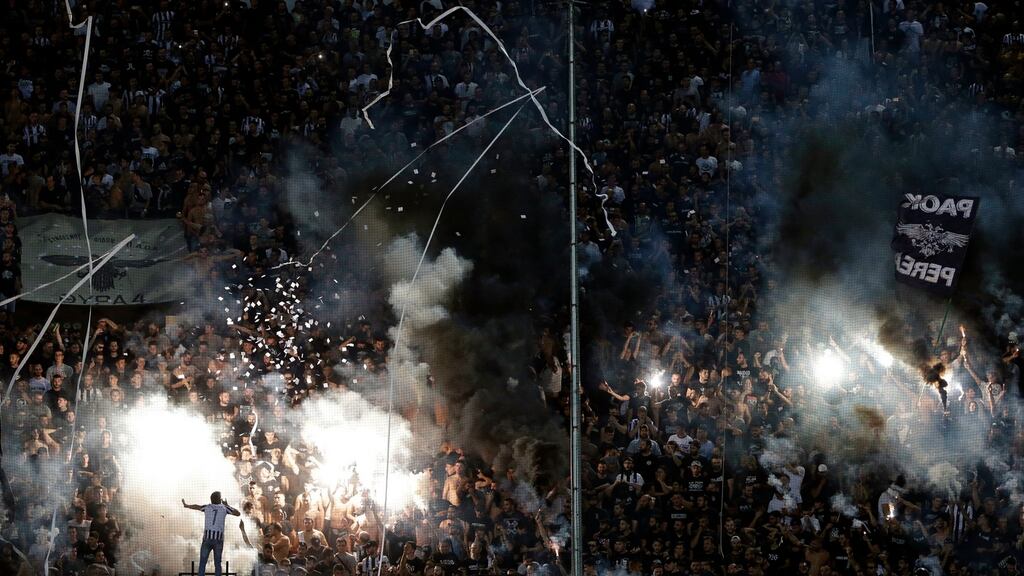PAOK’s fans light fireworks during their team’s defeat to Chelsea. Photograph: PA
