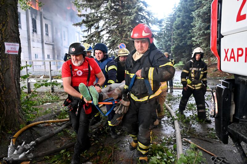 Rescuers carry a wounded person from the ruins of a civilian plant following Russian strikes on Kharkiv. Photograph: Getty Images