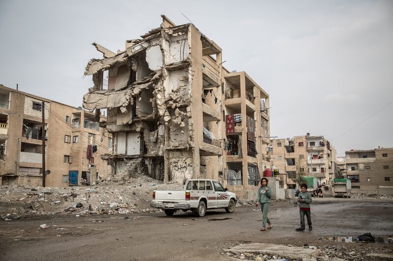 Children Walk through Raqqa's devastated Mesaken al Shuhada neighborhood. Photograph: Sally Hayden