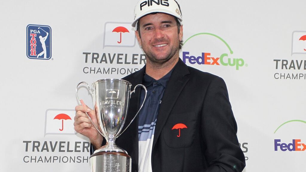 Bubba Watson poses for photos with the trophy after winning the Travelers Championship on the PGA Tour. Photo: Stew Milne/AP Photo