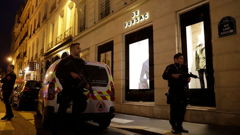 Policemen stand guard in Paris centre after one person was killed and several injured in a knife attack in the city. Photograph: Thomas Samson/AFP/Getty Images