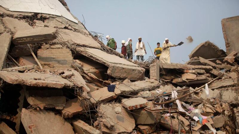 Rescue workers look for trapped garment workers at the collapsed Rana Plaza building in Savar, outside Dhaka, Bangladesh. Photograph: Andrew Biraj/Reuters