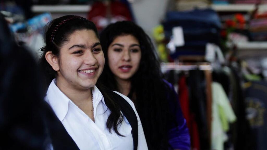 Leonarda Dibrani shops in the town of Mitrovica in Kosovo on Saturday. French President François Hollande said Dibrani, a 15-year-old schoolgirl whose expulsion from France has sparked uproar, could return to pursue her studies but without her family, a compromise that followed criticism from left-wing allies. Photograph: Reuters/Hazir Reka