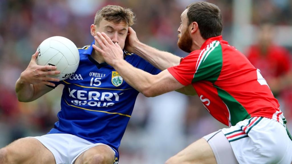 Kerry’s James O’Donoghue is closely shadowed by Keith Higgins of Mayo at Croke Park.  Photograph: Cathal Noonan / Inpho