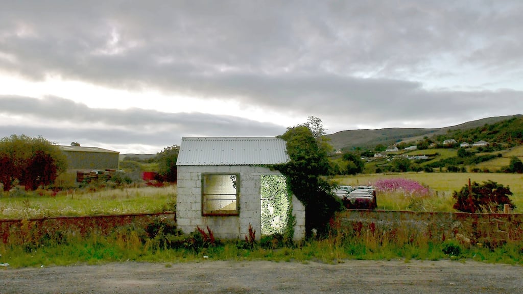 A former customs guard hut is illuminated on the Irish Border  in Ravensdale, Ireland. Photograph:  Charles McQuillan/Getty