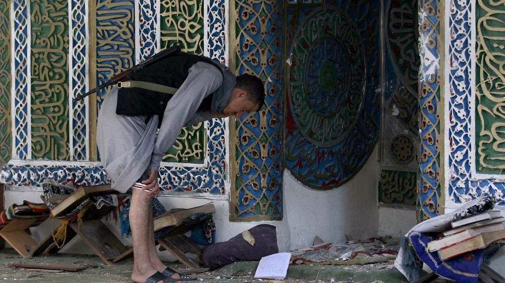 A Yemeni Huthi rebel looks at debris in the Balili mosque following an explosion that killed 10 people. Photograph: AFP Photo/Getty Images