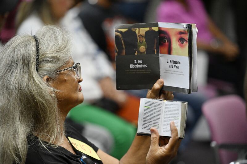 A woman reads during a meeting with local human rights groups and relatives of those detained during protests following the Venezuelan presidential elections, at the Foro Penal group's headquarters in Caracas. Photograph: JUAN BARRETO/AFP via Getty Images