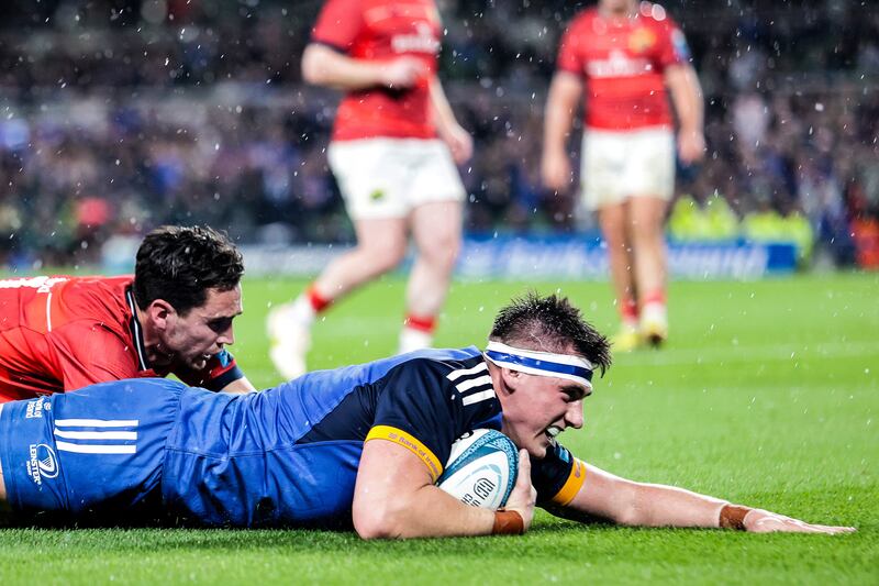 Leinster's Dan Sheehan scores a try despite the attention of Munster's Joey Carbery. Photograph: Inpho