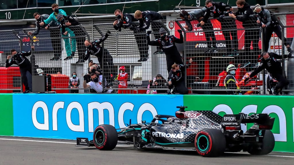 Formula One driver Lewis Hamilton and his Mercedes team celebrate winning the Formula One Eifel Grand Prix. Photograph: EPA