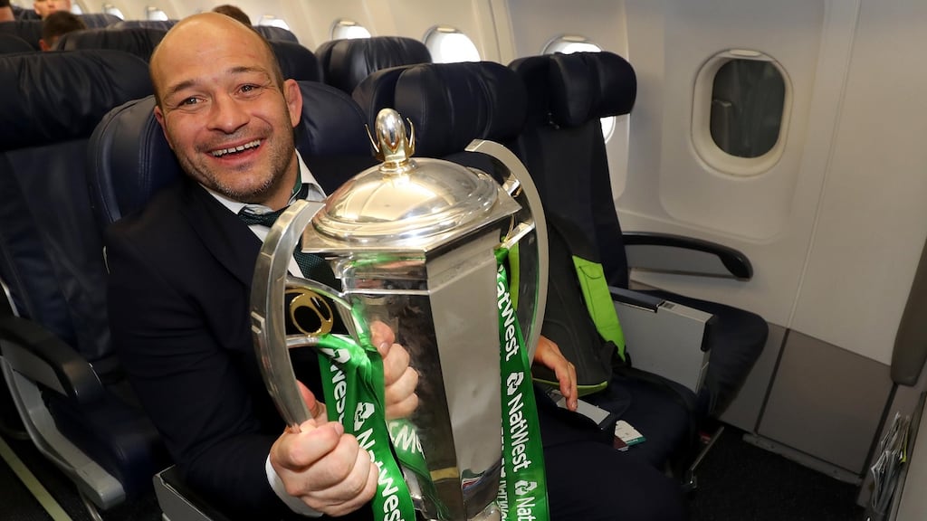 Rory Best with the Six Nations trophy on the team’s flight back to Dublin. Photograph: Inpho