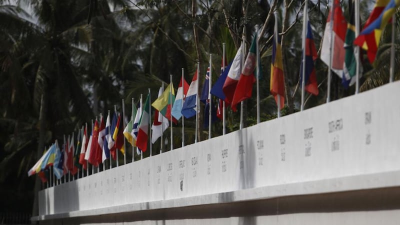 Dozens of national flags remembering the victims of the 2004 tsunami fly during a multi-faith service at the Tsunami Memorial Wall near Mai Khao Beach on Friday in Phuket, Thailand. Photograph: Getty