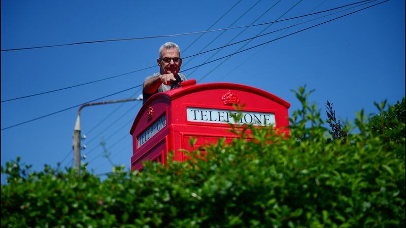 Paul Murphy with the English phonebox he has restored. Photograph: Bryan O’Brien