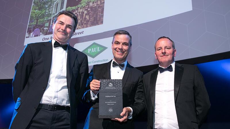 Liam Kenny, Deputy Managing Director, John Paul Construction presents the Building of the Year award to Ronan Savage & Finghín Curraoin, Henry J Lyons.