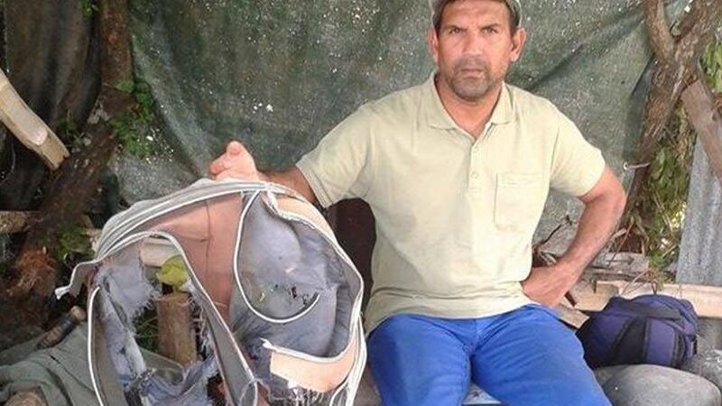 Johnny Begue, a member of a local shore cleaning association with the remain of a suitcase found at the same site where he and his fellow association members also found a two-metre piece of plane wreckage that could be from the missing flight MH370. Photograph: AFP