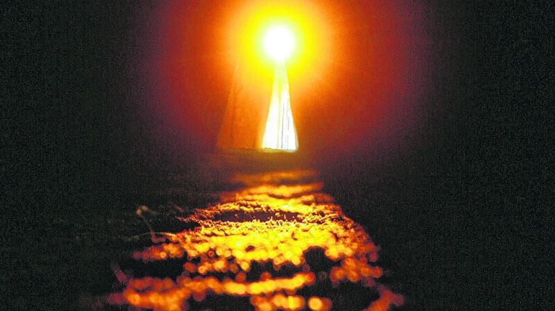 A stream of sunlight passes through the window box and along the passageway leading into the burial chamber of Newgrange during the 2006 winter solstice, 21st December. Photograph: Alan Betson