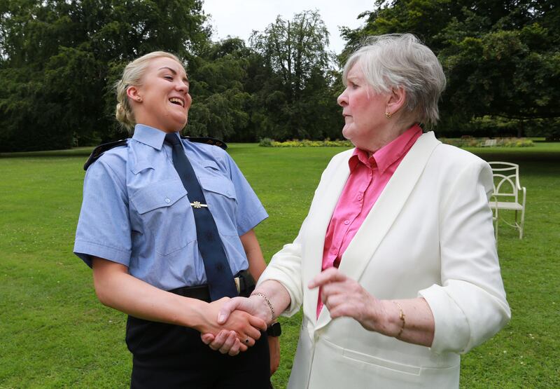 PASSING THE BATON: New garda recruit, Christine Ni Dheashuna, with retired garda Brid Wymbs, at an event in Farmleigh House marking the 60th anniversary of women being permitted to join the Garda. Photograph: Crispin Rodwell