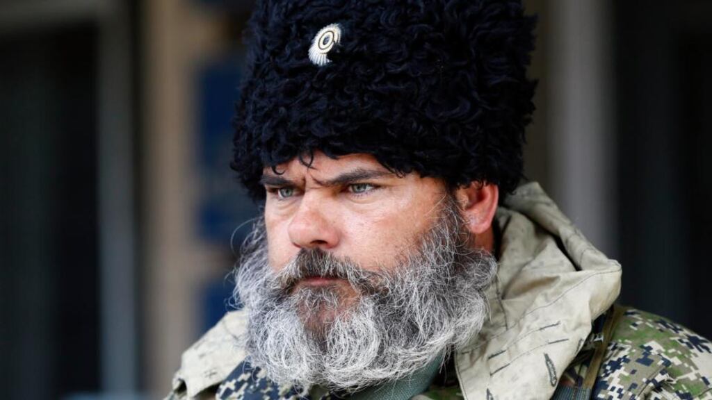 A pro-Russian armed man looks on near the mayor’s office in Slaviansk. Eastern Ukraine seems to be rapidly spinning out of the control of the central government. Photograph: Gleb Garanich/Reuters