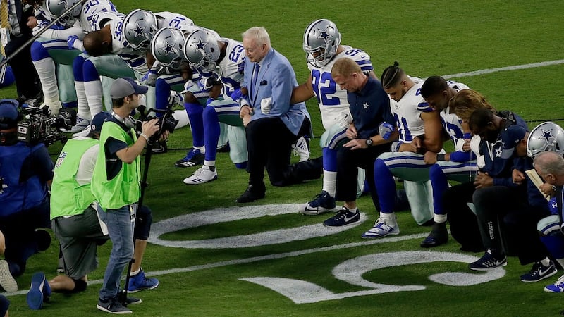 The Dallas Cowboys, led by owner Jerry Jones, take a knee prior to the national anthem prior to an NFL football game against the Arizona Cardinals on Monday. Photograph: Matt York/AP
