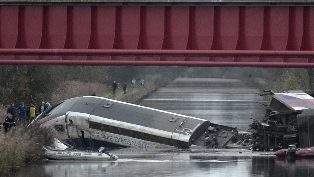 Rescuers work at the scene where a high-speed TGV train coach and engine carriage lie in a canal in Eckwersheim near Strasbourg, northeastern France, after derailing on November 14th, 2015. Photograph: Frederick Florin/AFP/Getty Images