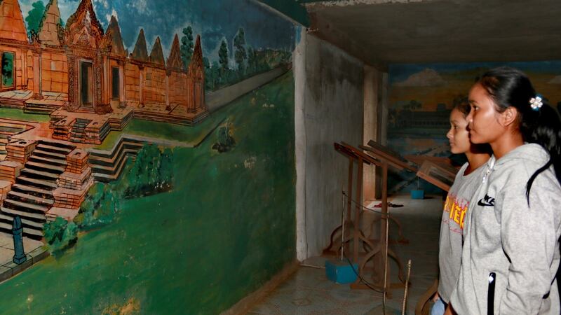 Schoolgirls from the former Khmer Rouge stronghold of Anlong Veng visit the home of Khmer Rouge official Ta Mok, known as Pol Pot’s “butcher”. Photograph: Nevenka Lukin