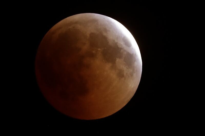The moon in total lunar eclipse above the Lebanese town of Tannourine in the mountains north of Beirut. The longest "blood moon" eclipse this century began on July 27th, coinciding with the closest approach in 15 years by Mars. Photograph: JOSEPH EIDJOSEPH EID/AFP/Getty Images