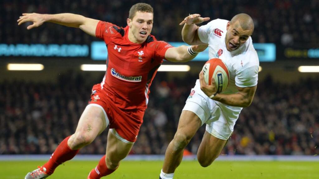 England’s centre Jonathan Joseph evades the tackle of Wales winger George North to score a try during the Six Nations match at the Millennium Stadium in Cardiff. Photograph: Glyn Kirk/AFP