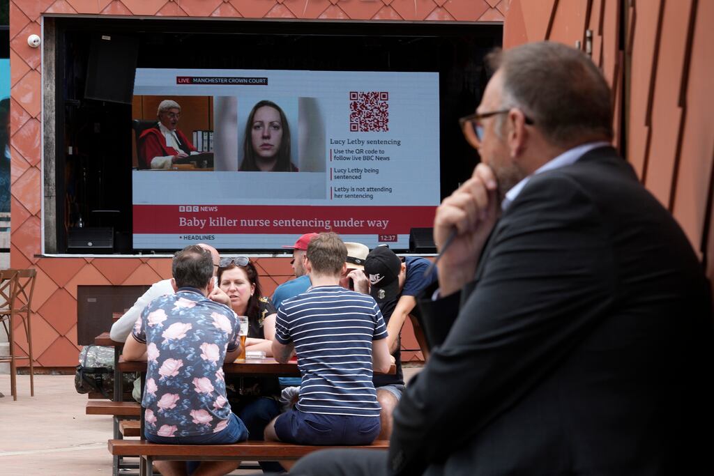 A TV screen near Manchester Crown Court broadcasts the judge sentencing Lucy Letby to whole-life orders for murdering seven babies, and attempting to murder six more. Photograph: Christopher Furlong/Getty