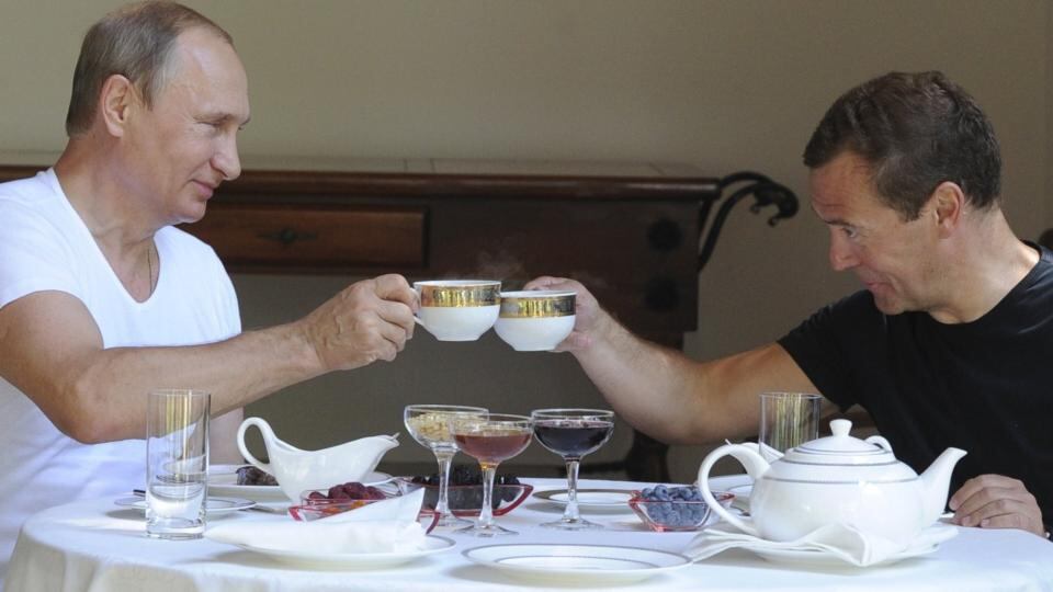 Vladimir Putin and Dmitry Medvedev toast with tea cups during breakfast in Sochi. Photograph: Reuters