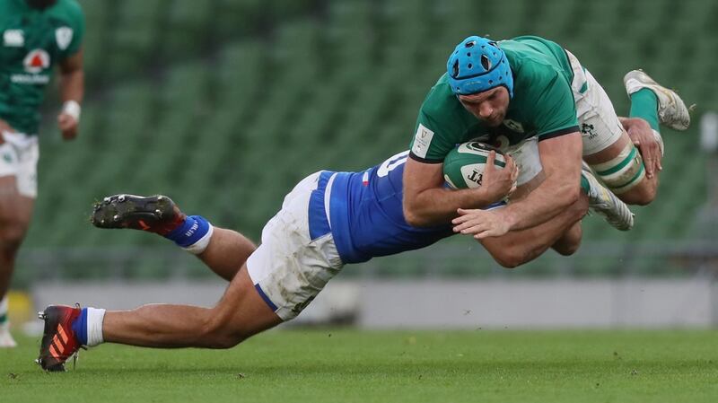 Tadhg Beirne is tackled by Gianmarco Lucchesi of Italy.Photograph: Brian Lawless/EPA