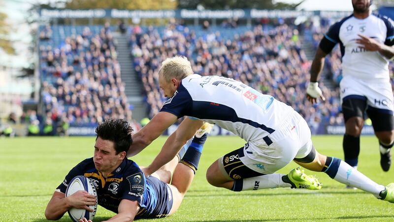 Joey Carbery scores Leinster’s first try despite the attentions of Montpellier’s Jesse Mogg during the Champions Cup pool three match at The RDS Arena. Photograph: Brian Lawless/PA Wire