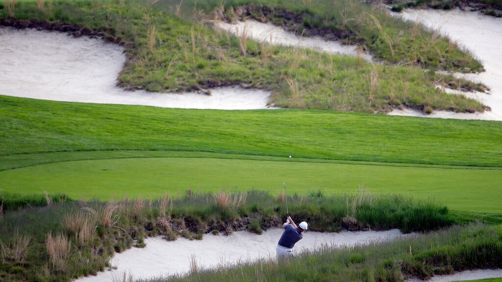 Graeme McDowell hits out of the bunker on the fourth hole during the first round of the PGA Championship at Bethpage Black. Photo: Seth Wenip/AP Photo